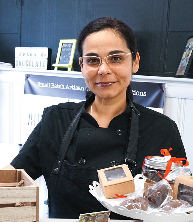 A chocolate maker posing for a photo