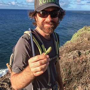 Dustin Wolkis holds a Maiapilo plant seed.