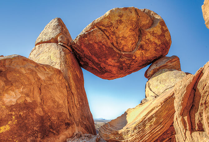 A huge boulder balanced between two rocks