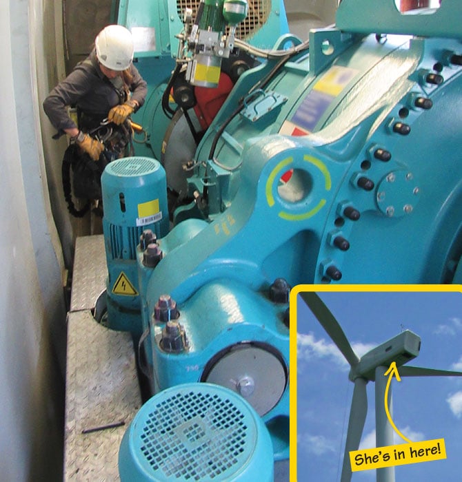 A person in a helmet standing next to a giant machine