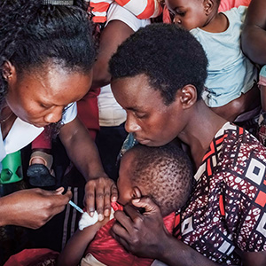 Photo of a child receiving a vaccine for protection from malaria