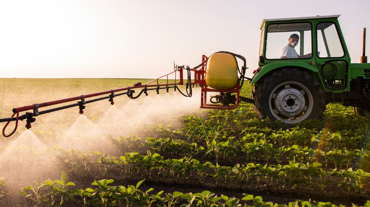 Photo of farmer spraying fields with insecticide