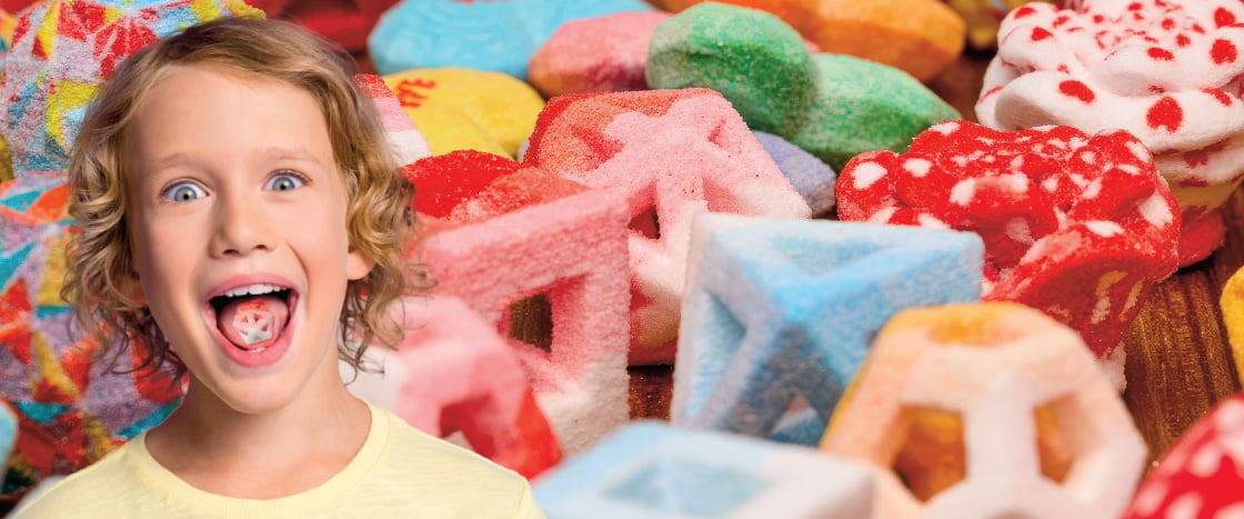 Image of a kid eating 3D candy while surrounded by a variety of 3D candy