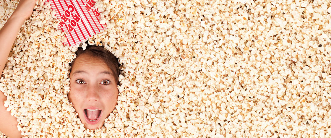 Image of person covered in popcorn besides their head