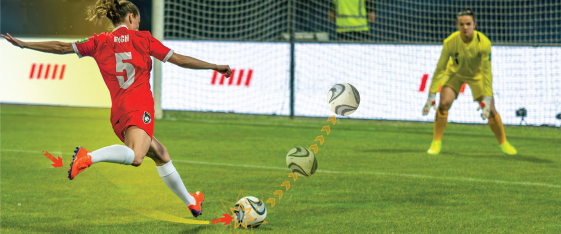 Image of soccer playing kicking ball into net