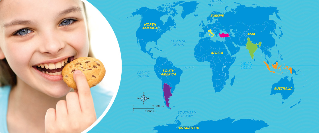 Image of kid eating cookie against world map