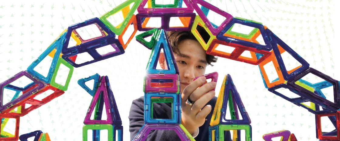 Image of teen playing with toy magnets