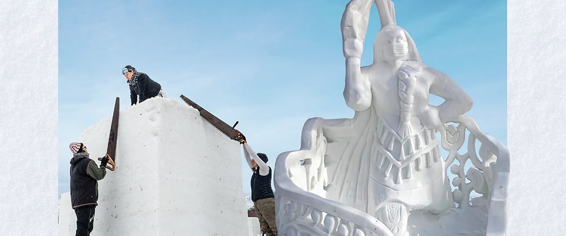 Image of people creating carving out of snow