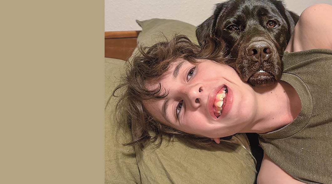 Image of teen pictured with guide dog