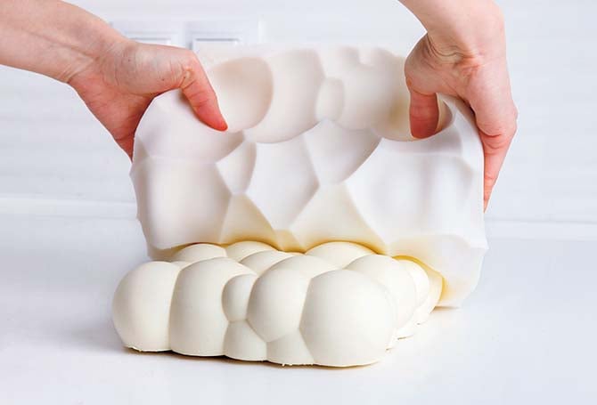 A person taking a cake out of its mold