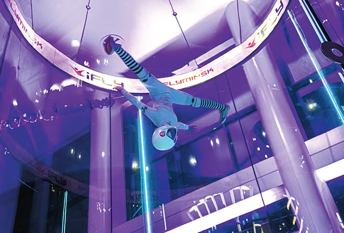 Person flying upside down in an indoor flyzone